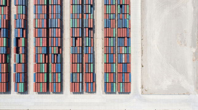 Aerial view of container terminal at dusk with cargo stacks