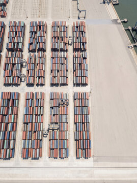 Aerial view of container terminal at dusk by harbor
