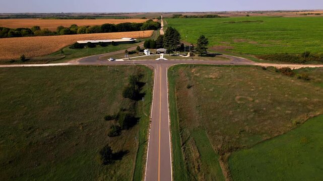 Aerial rising above a country road junction on the Great Plains