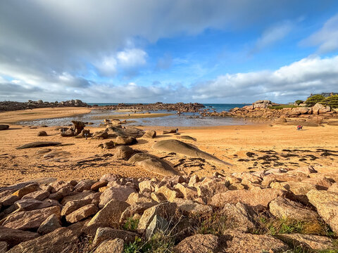 Sandy bay with granite reefs and tidal pools in Tregastel, France