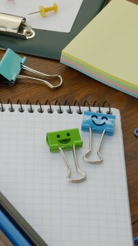 Pencils, paper clips, push pins create functional workspace on desk. Bright stationery. Office and school tools enhance creativity and efficiency