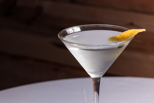 The classic Vesper Martini, served in a tall martini glass on a wooden background.