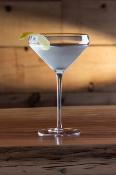 The classic Vesper Martini, served in a modern coupe glass on a wooden background.