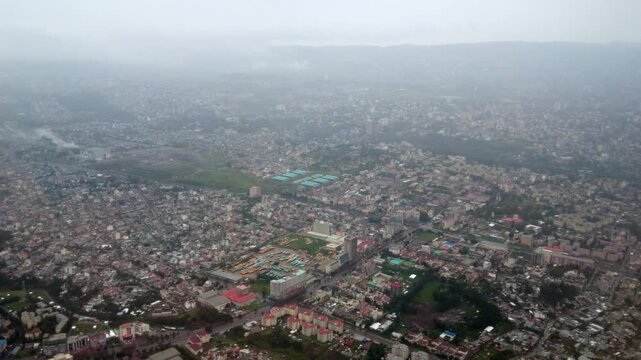 Aerial flyover of the large African city of Addis Ababa, Ethiopia during a rainstorm.
