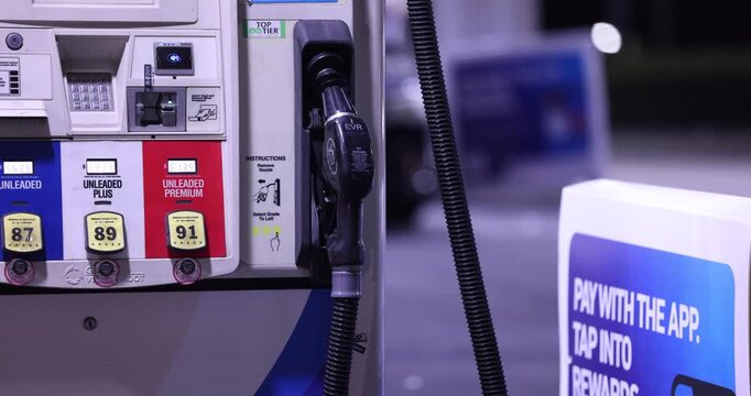 Fullerton, California, USA - September 14, 2026: Vehicles refuel at a gas station with prices surging due to the ongoing war with Iran. 