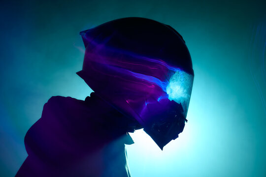 Cinematic close-up of person in motorcycle helmet with colorful smoke swirling around, blue and purple neon light, dark background