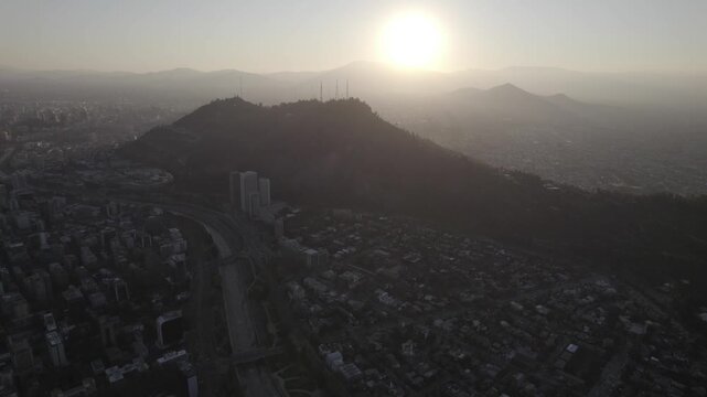 Aerial Drone Forward Shot Of Cerro San Cristobal Silhouettes At Sunset In Santiago