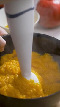 Warm mashed pumpkin mixture prepared by hand. Smooth texture reveals cooked, grinding autumn vegetable. Fresh harvest turned into nourishing dish with rich color and homemade care