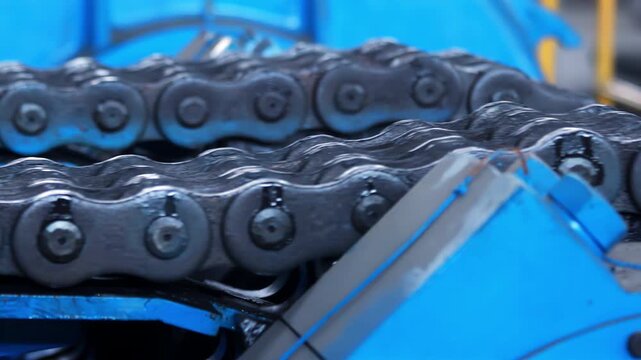 Roller chain drive close up. Industrial machine transmission factory production.
