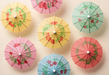 Naklejka premium Summer party and tropical cocktail decoration, colorful paper umbrellas with floral patterns arranged on a light background for festive celebration