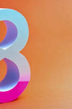 A simple design featuring the number 8 in white on a bright orange background. vertical frame