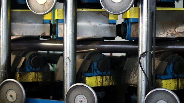 Close up pressure gauge tube mill roller. Metal pipe forming machinery plant.