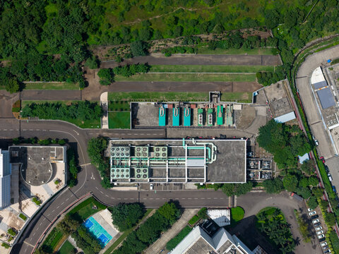 Aerial view of Nxtra Data Centre featuring industrial cooling units on the rooftop, surrounded by lush greenery and paved roads in Hinjawadi, Maharashtra, India.