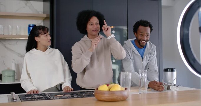 African American trio filming demo kitchen island ringlight phone recording leading right mixing
