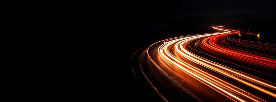 Light trails on a winding highway at night with long exposure photography, glowing vehicle light streaks on a dark mountain road background