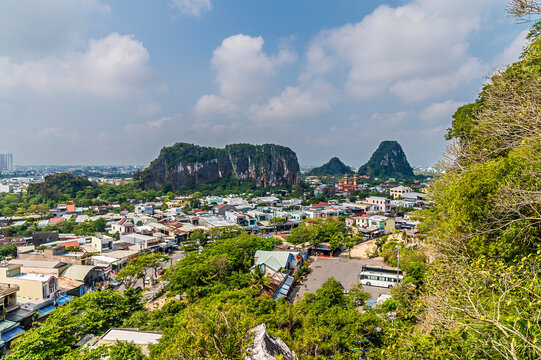 A view overlooking the town and limestone peaks from the Marble Mountains in Da Nang, Vietnam on a bright sunny day