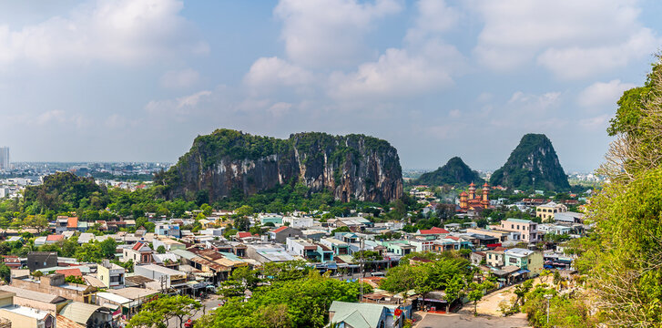 A view towards limestone peaks from the Marble Mountains in Da Nang, Vietnam on a bright sunny day