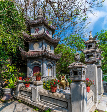 A view towards a traditional multi level stone pagoda and shrine at the Marble Mountains in Da Nang, Vietnam on a bright sunny day