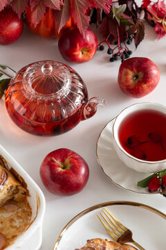 Autumn tea time with fresh apples and baked dessert on white table