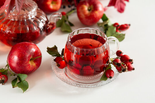 Refreshing Red Tea With Apples and Rose Hips Serve in Glassware With Delicate Floral Garnish