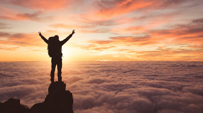 A golden-hour 16-9 widescreen wallpaper featuring a backpacker silhouette standing triumphant above a sea of clouds at sunset.
