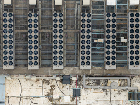Aerial view of the Nxtra Data Centre rooftop featuring rows of industrial cooling fans and HVAC units with complex piping systems in Hinjawadi, Maharashtra, India.
