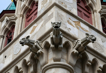 Obraz premium Gothic architecture and medieval history, stone gargoyles on historic building facade with intricate carvings and ornate masonry details in urban setting