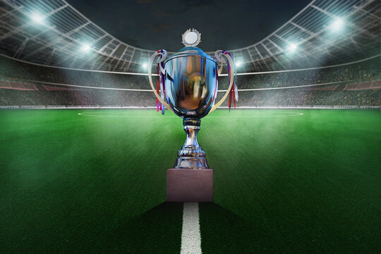 Soccer sport cup on the big textured soccer game field, stadium. Ready for game in the midfield