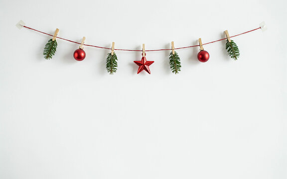 Decorative Christmas garland with pinecones and ornaments hanging on a string