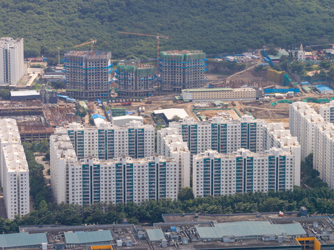 Aerial view of the Hinjewadi Phase III residential area featuring modern apartment complexes and ongoing construction with cranes in Pune, Maharashtra, India.