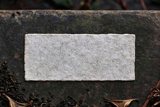 Handmade paper sheet on dark stone background with organic rustic mood