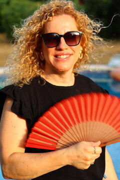 Smiling Woman Enjoying a Sunny Summer Day by the Pool