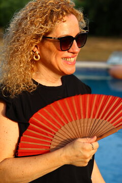 Smiling Woman Enjoying a Sunny Summer Day by the Pool