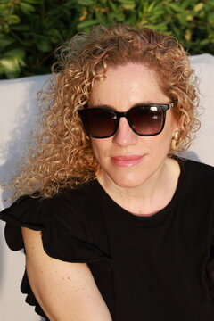 Smiling Woman Enjoying a Sunny Summer Day by the Pool