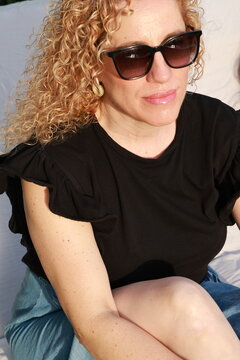 Smiling Woman Enjoying a Sunny Summer Day by the Pool