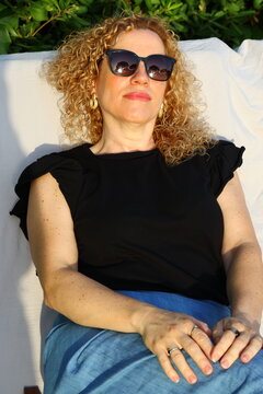 Smiling Woman Enjoying a Sunny Summer Day by the Pool
