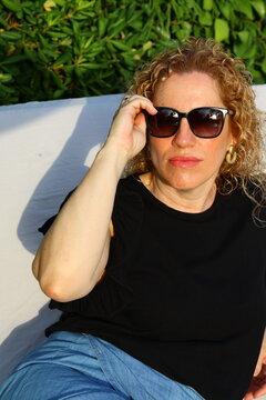 Smiling Woman Enjoying a Sunny Summer Day by the Pool