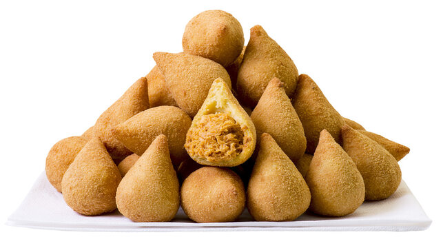 Isolated pile of golden-brown crispy Brazilian coxinhas, delicious chicken croquettes appetizer
