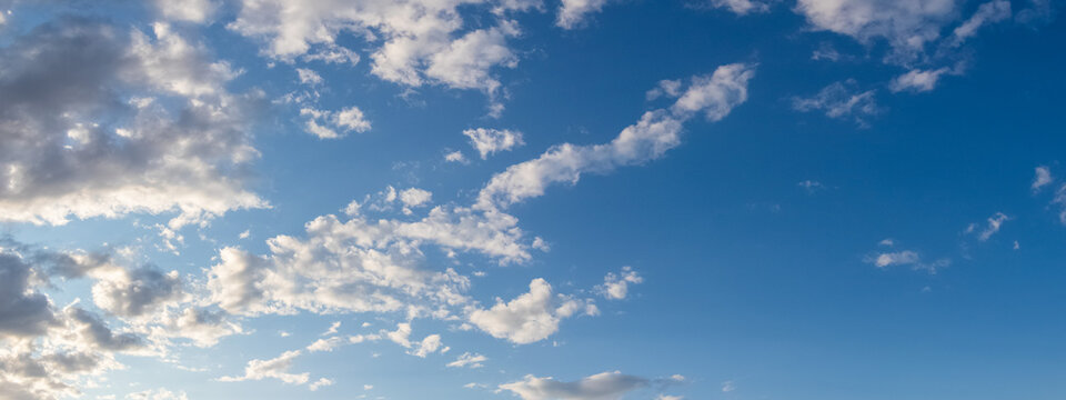 Blue sky with white fluffy clouds in daytime