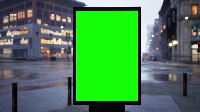 Vertical green screen citylight sign on a busy city street on a bright morning, wet streets after rain. Time lapse of city traffic, bokeh lights and moving cars. Clean chroma key area for compositing