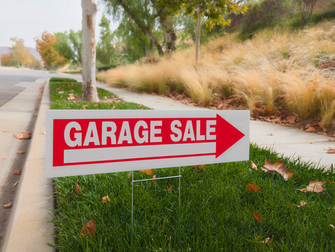 Yard Sale Sign with Direction Arrow on Side of Street