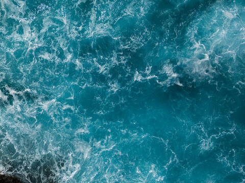 Abstract aerial view of rough ocean waves forming natural water patterns