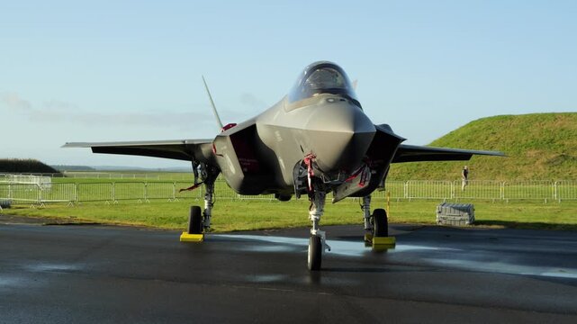 Stealth F-35 fighter jet standing on military air base runway