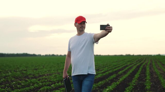 Agriculture, Farmer s day out, Crops and camera moments, Modern man on the farm, Field stories through selfies, Social farming lifestyle, Man taking photos on farmland, Smartphone farming revolution