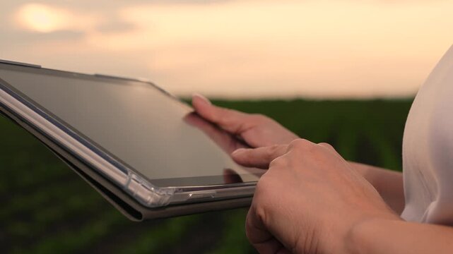 Agriculture, Rural technology adoption, Smart agriculture at dusk, Touchscreen innovation on farm, Crop data logging outdoors, Digital ecosystem in farming, Precision monitoring of plants, Technology