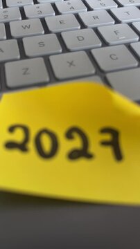 2027 goals sticky note on keyboard remote work planning