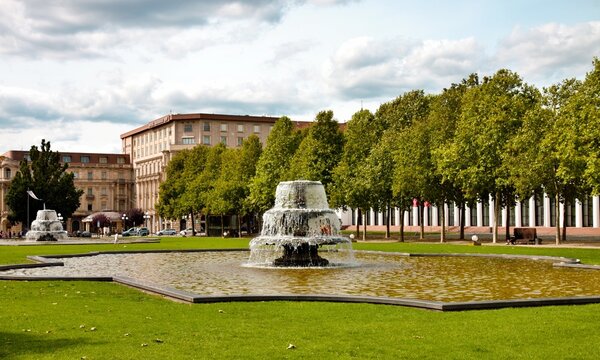 Wiesbaden, Hesse, Germany: Bowling Green park with cascading fountains green lawn and tree lined urban scenery.