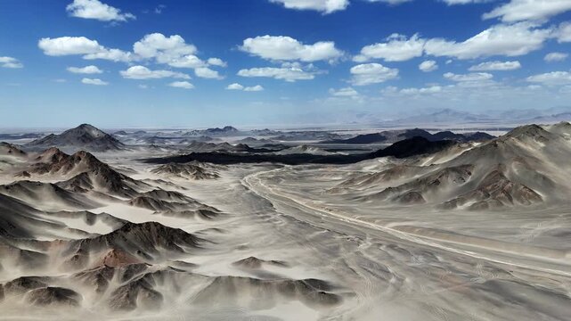 Black Dushan barren Gobi desert landscape under blue sky and white clouds