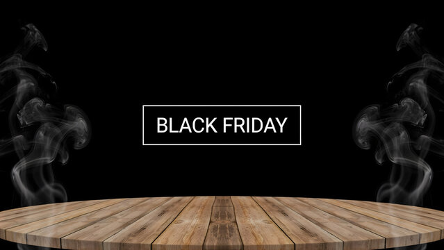 Black friday promotional sign with white text in a frame, surrounded by rising smoke on a wooden table surface against a black background