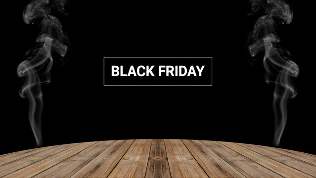 Black friday promotional sign with white text in a frame, surrounded by rising smoke on a wooden table surface against a black background